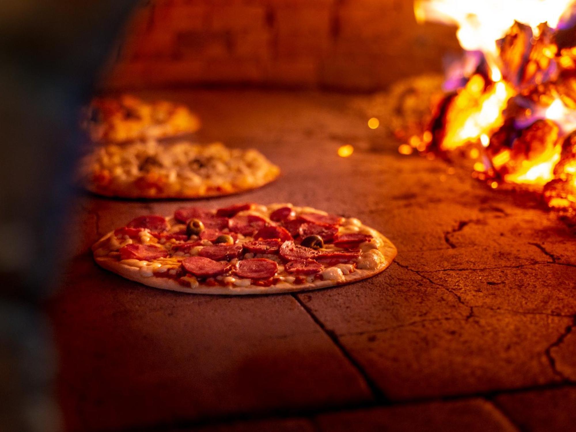 Ocean Palace All Inclusive Premium Natal Exterior photo Pizza being cooked in a wood-fired oven